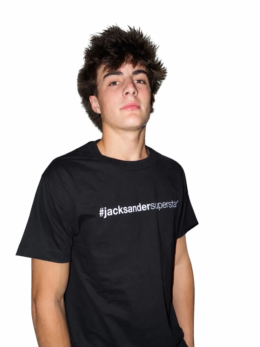 Front portrait in a black jacksandersuperstar tee, with tousled hair and arms relaxed.