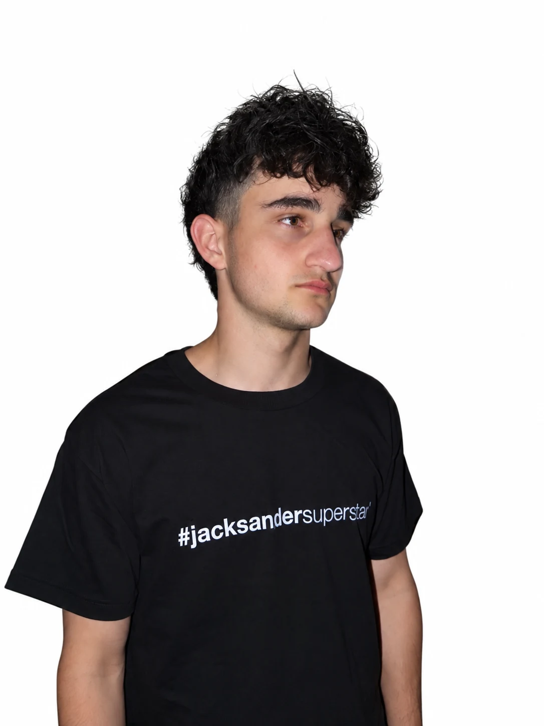 Three-quarter portrait in a black jacksandersuperstar tee, looking to the right.